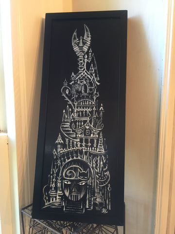 head-on photo of a painting in a simple black frame. the painting is a white-on-black image of a strange tower with a gate. shaped like Emily the Strange's face and a claw-like spire. the painting is sitting on an intricate black wire stool and leaned against a cream white wall