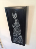 a top-right shot of the painting hung on an off-white wall