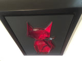 same red kitty gem on black shot from a top down angle